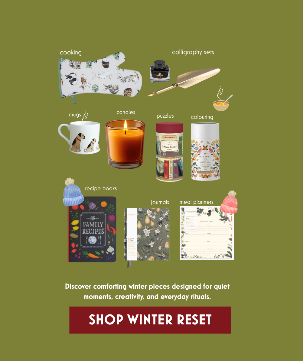 Collection of items including a mug, candle, and books on a green background with text promoting 'Shop Winter Reset'.